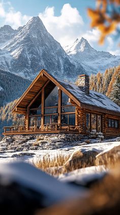 a cabin in the mountains with snow on the ground