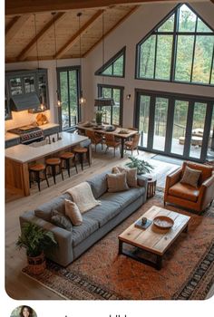 a living room filled with furniture next to a kitchen and an open concept floor plan