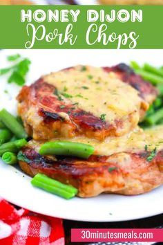 honey dijon pork chops on a plate with green beans