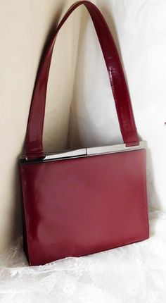 Jones New York Women's Handbag Burgundy Leather Clasp Style Purse 8" x 9' x 2 1/4" - Strap Drop 9".   Very Good Condition! There is one tiny white mark on the bottom edge - See photos for further description.  This is a beautiful, very classy bag.  It reminds me of something that Jackie O. would have used.  Questions welcome! Red Square Satchel For Formal Occasions, Red Square Formal Satchel, Vintage Red Shoulder Bag For Business, Red Vintage Shoulder Bag For Business, Retro Red Shoulder Bag For Formal Occasions, Retro Red Formal Shoulder Bag, Formal Retro Red Shoulder Bag, Jackie O, White Mark