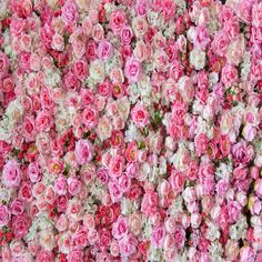 many pink and white flowers are arranged in a pattern on the wall, as well as one another