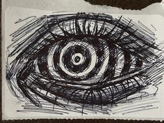 an eye drawn on paper with black ink