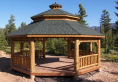 a wooden gazebo sitting on top of a dirt field