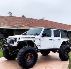 a white jeep parked in front of a house