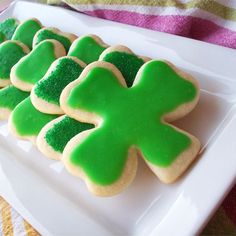 some green and white decorated cookies on a plate