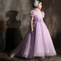 This DreamyVow Elegant Lilac Dubai Girl Dress is perfect for your child's special occasions. Handmade flowers adorn the princess-style gown, creating a stunning and unique look. Ideal for birthdays, weddings, or holidays, your child will feel like royalty in this elegant dress. Available in a variety of sizes for the perfect fit. Purple Ball Gown Princess Dress For Wedding, Purple Floor-length Ball Gown For Pageant, Princess Style First Communion Dress For Pageant, Princess Ball Gown For First Communion, Princess Gown For Debutante Ball, Princess Style Ball Gown With Fitted Bodice, Princess Style Dress With Fitted Bodice Floor-length, Princess Style Floor-length Dress With Fitted Bodice, Floor-length Princess Dress With Fitted Bodice