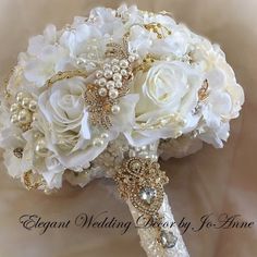 a bridal bouquet with white flowers and pearls