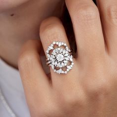 a woman's hand with a diamond ring on it