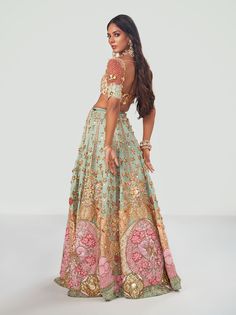 Editor's Note Featuring a stunning Sangeet look with a bejeweled tone as styled by Ami Patel in South Asian Bride 101. A teal green tulle lehenga embroidered with custom cut acrylic pieces, gold metal embellishments and appliqué of rich fabric. It is paired with a teal green embroidered bralette and delicate tulle pre-draped dupatta with tasseled gold metal embellishments. Color: Teal green Fabric: Tulle Neckline: Sweetheart Sleeve type: Half Embroidery details: Acrylic pieces, gold metal embell Unique Mehendi Outfits For Bride, Mehendi Bridal Outfit, Turquoise Lehenga, Teal Lehenga, Haldi Outfits For Bride, Punjabi Clothes, Mehendi Outfits For Bride, Sangeet Look, Unique Lehenga