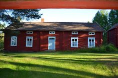 an old red house with white doors and windows