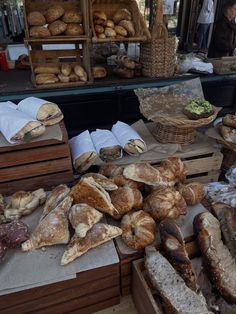 breads and pastries are on display at an outdoor market