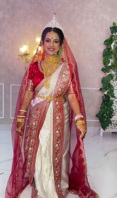 a woman in a red and white wedding outfit