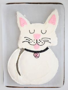 a cake shaped like a cat with pink ears