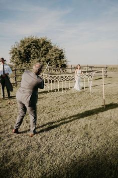 a bride and groom are taking pictures in the field