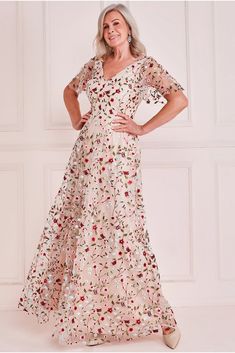 The flutter sleeve floral embroidered maxi dress is a perfect fit for a mature woman attending a formal occasion like a wedding. The delicate and feminine flutter sleeves combined with the romantic floral embroidery create a whimsical and dreamy look, perfect for the mother of the bride or mother of the groom. The mod Angel Sleeves Dress, Floral Evening Dresses, Flowing Fabric, Nude Dress, Groom Dresses, Cream Colour, Embroidered Maxi Dress, Ladies Gown, Whimsical Fashion