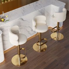 three white bar stools in front of a marble counter