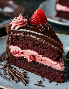 a piece of chocolate cake on a plate with strawberries