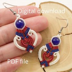 a pair of beaded earrings with blue and red beads is shown in front of a piece of wood