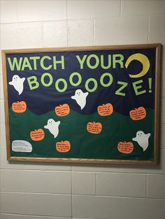 a sign on the wall that says watch your booooze with ghostes and pumpkins