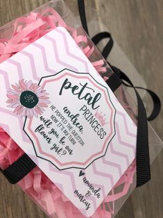 a package of petal princess hair ties in pink and black packaging on a wooden floor