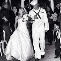 a bride and groom walking down the aisle