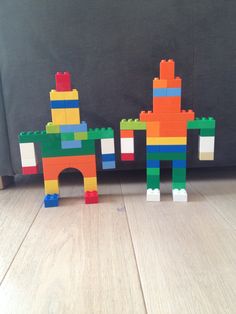 two legos made to look like they are standing next to each other on the floor