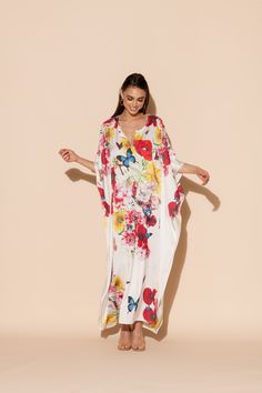 This is one Bouquet you won't want to throw away! Vibrant blooms of flora and fauna adorn this long caftan in our signature Polysilk fabric. Dance the night away or lounge in luxe - the occasions are endless with this beautiful, blossoming statement piece. Machine washable for ease of care. Spring V-neck Kaftan With Digital Print, Silk Floral Print Kaftan For Beach Cover-up, Spring Digital Print Kaftan, Summer Dresses With Digital Print And Kimono Sleeves, Spring Dresses With Digital Print And Kimono Sleeves, Beachwear Silk Dress With Floral Print, Elegant Floral Print Flowy Kaftan, Elegant Red Floral Print Kaftan, White Silk Dress With Digital Print