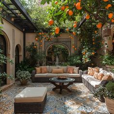 an outdoor living room with oranges hanging from the ceiling