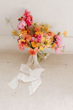 a bouquet of flowers is sitting on the floor