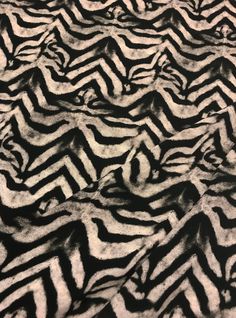 black and white zebra print fabric with very thin lines on the top part of it