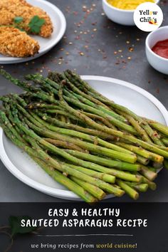 asparagus on a plate next to other dishes