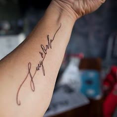 a person with a tattoo on their arm that says, love and faith in cursive writing