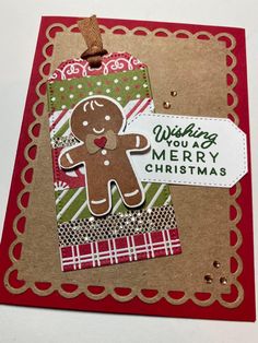 a christmas card with a ginger on it and a tag hanging from the bottom that says wishing merry christmas