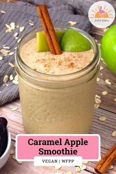 caramel apple smoothie in a mason jar with cinnamon and an apple on the side