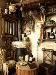 an old fashioned kitchen with rustic decor and wood accents on the walls, along with wooden furniture