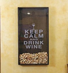 there is a sign that says keep calm and drink wine on the side of a wall