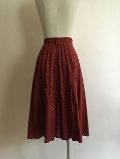 "Lightweight red plaid 1970s circle skirt zips up in the back with a single button at the waist to secure closure. Skirt has vague permanent pleats and is made of a very lightweight poly/cotton blend. In very good vintage condition. There is only one label present,\"DRY CLEAN ONLY\". Waist 26\" Hips 28\" Length 28\"" High Waist Retro Pleated Skirt, Red Retro Pleated Skirt, Retro Full Lined Skirt, Retro Skirted Bottoms For Fall, Retro Red Pleated Bottoms, Retro Red Gathered Skirt, Retro Pleated Full Skirt Bottoms, Vintage Plaid Full Skirt, Retro Plaid Flared Skirt