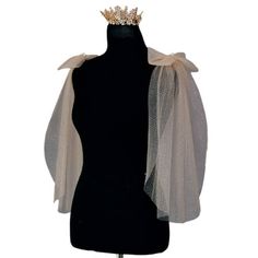 a mannequin wearing a black dress and a crown