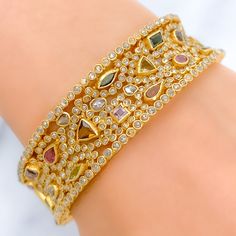 PRODUCT DETAILS Gold Purity(karat): 22k Item Weight(grams): 46.7 Item Finish: Yellow Gold Stone: Polki Diamond Diamond Weight(carats): 10.55ct Accented Stone: Tourmaline Stone Weight: 6.44ct Bangle Size: 2.4 Bangle Opening: 2.25" Openable: Yes, Hinge w/ Screw 22k Gold Bangles, Yellow Gold Bangle, Gold Necklace Set, Tourmaline Stone, Luxurious Design, Gold Bangle, Gold Stone, 22k Gold, Gold Bangles