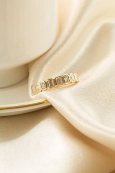 a white cup and saucer sitting next to each other on top of a table