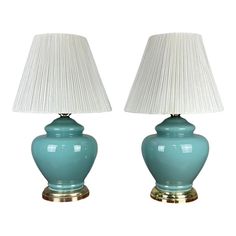 two blue lamps sitting next to each other