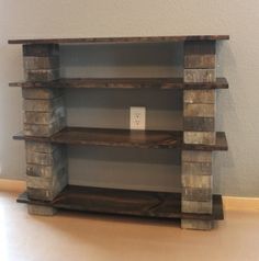 a shelf made out of wooden blocks with a light switch on it's side