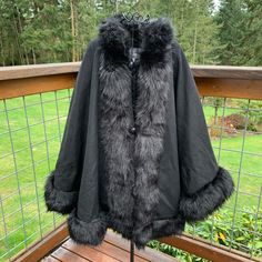 This A Brand New Cape With No Tags On It. Purchase Price- $215.00. It Is A Deep Black Color--The Sun Lightened The Color In Pictures. Made Of 48% Wool, 42% Polyester And 10% Other Fibers. Lining Is 100% Polyester. Faux Fur Is 80% Acrylic And 20% Polyester. A Stylish Silhouette With Faux Fur To Instantly Elevate Your Cold-Weather Style. Button And Loop Closure. This Cape Is Fully Lined With Faux Fur Trim Around Edges. 3 Buttons Down Front With A Loop At Top. The Arms Have A Button Closure So You Elegant Faux Fur Cape Outerwear, Black Outerwear With Faux Fur Trim For Fall, Faux Fur Trim Cape For Cold Weather In Fall, Fall Cape With Faux Fur Trim For Cold Weather, Fall Cape Outerwear With Faux Fur Lining, Black Faux Fur Outerwear For Cold Weather, Black Outerwear With Faux Fur Trim For Cold Weather, Fall Cape With Faux Fur Lining, Elegant Black Outerwear With Faux Fur Lining