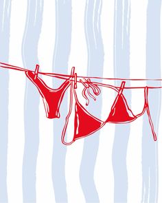 two red bikinis hanging on a clothesline against a blue background with vertical stripes