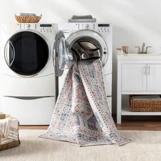 a white washer sitting next to a dryer in a room