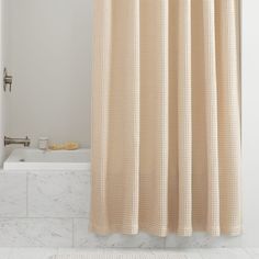 a bathroom with a shower curtain and bathtub