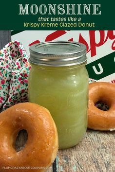 two glazed doughnuts sitting next to a mason jar