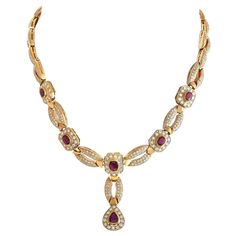 Go for full-on glamour with this diamond and ruby necklace. Designed with regal elegance in mind, this stunner features a Y-shaped chain composed of alternating pave-set oval links and ruby-punctuated octagonal plaques. The Y-tail terminates with a pear-shaped plaque with a pear ruby surrounded by round diamonds.Offered in estate condition, this 18K Yellow Gold 7.87 ct Diamond and 12.85 ct Ruby Y-Shaped Necklace comes with a gift box. Luxury Ruby Diamond Necklace With Accents, Luxury Ruby Diamond Necklace With Diamond Accents, Gold Ruby Necklace, Regal Elegance, Ruby Necklace, Mozambique, Pear Shaped, Round Diamonds, Pear