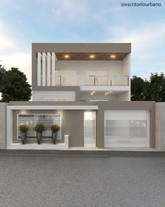 the front view of a two story house with white balconies and plants in pots