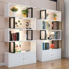 a living room with white shelves filled with books and vases on top of them